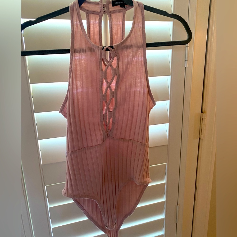 Light pink tank with open front.